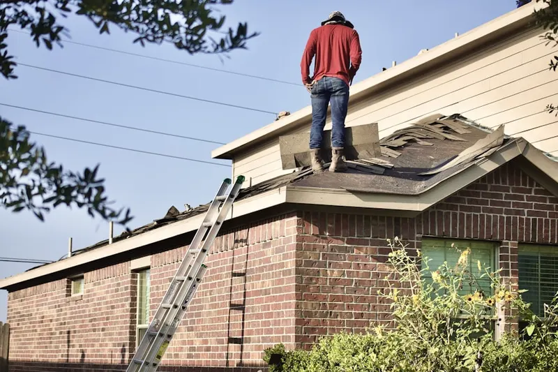 Professional roofer working on a residential roof in Sunfair